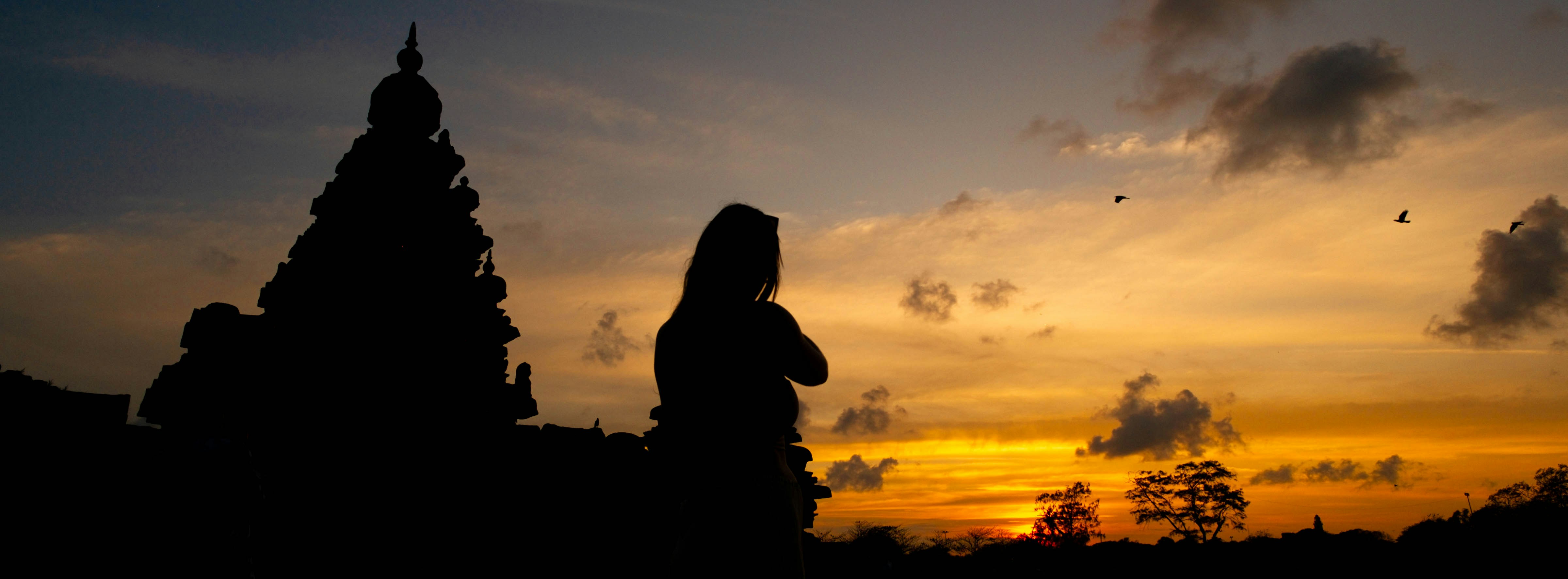 Cliffside temple at Uluwatu with sunset sky