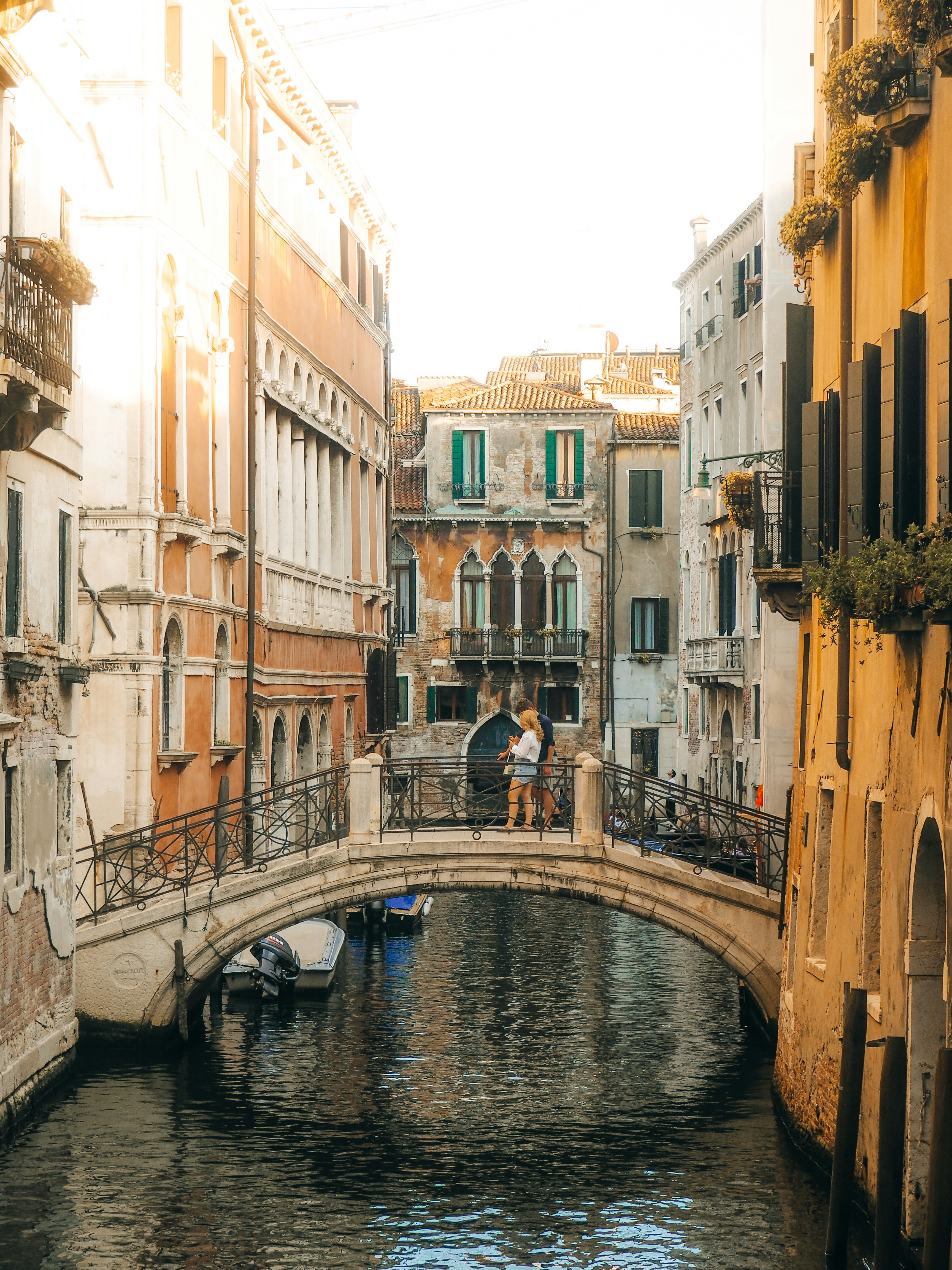 Couple enjoying a European cityscape at sunset during a honeymoon