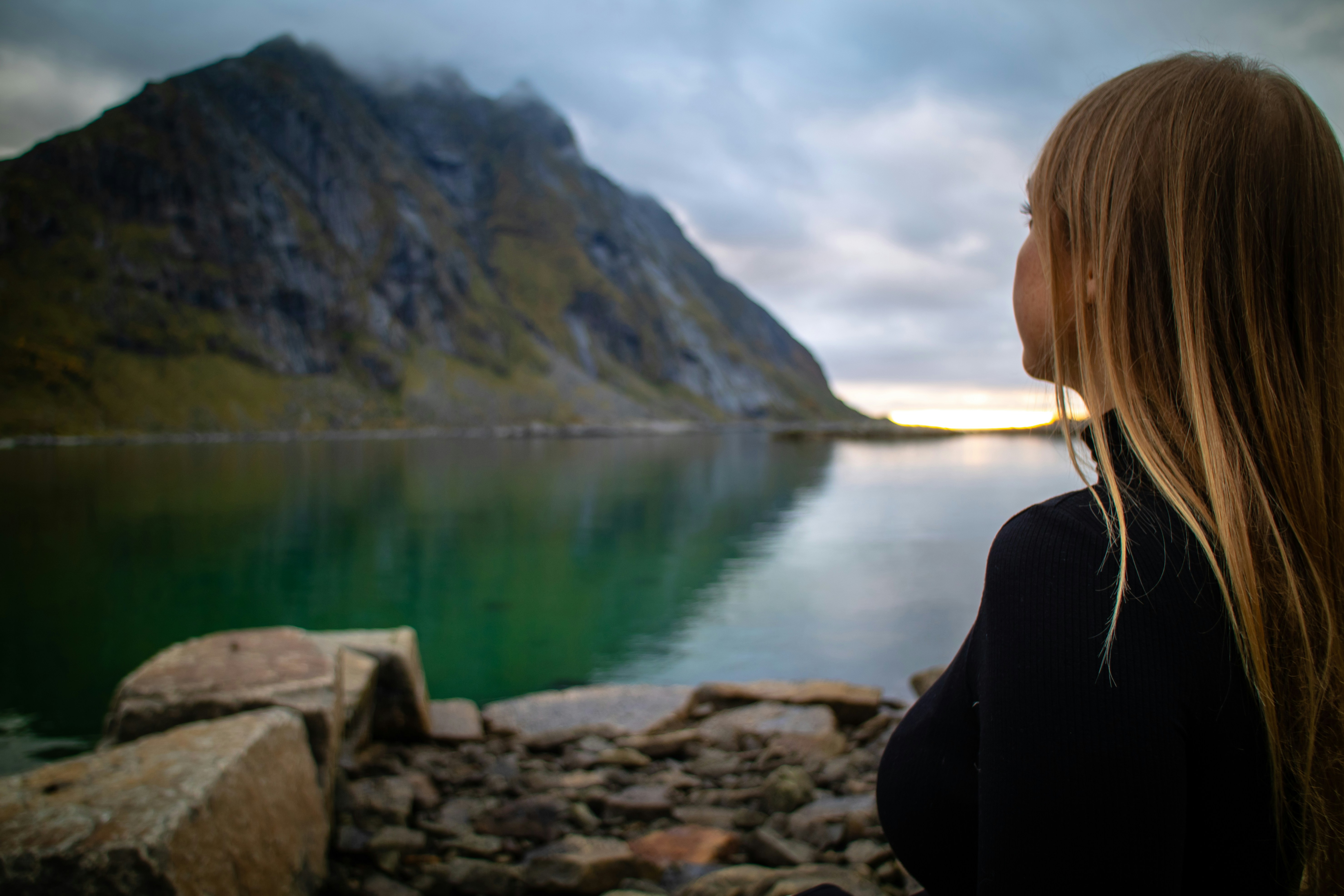 Solo traveler overlooking a city at sunrise with a backpack
